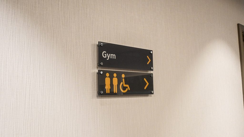 Maldron Hotel internal wayfinding signs. Acrylic panels directing users to Gym and toilets.