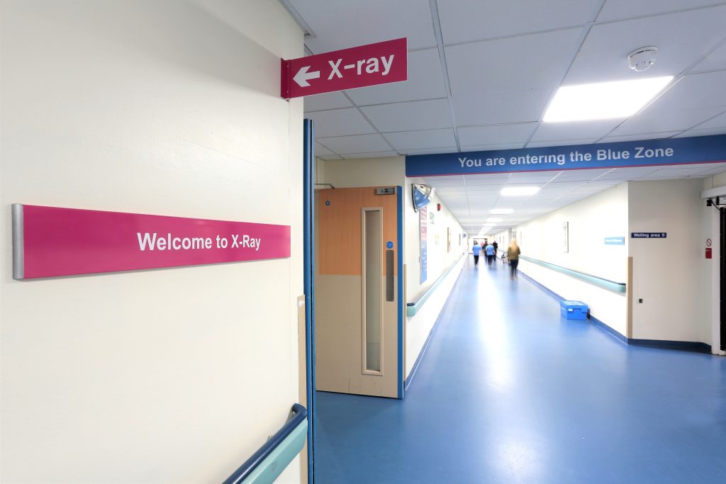 NHS Crosshouse Hospital Wayfinding signs. Wall mounted panel, projecting sign and ceiling mounted sign panel.