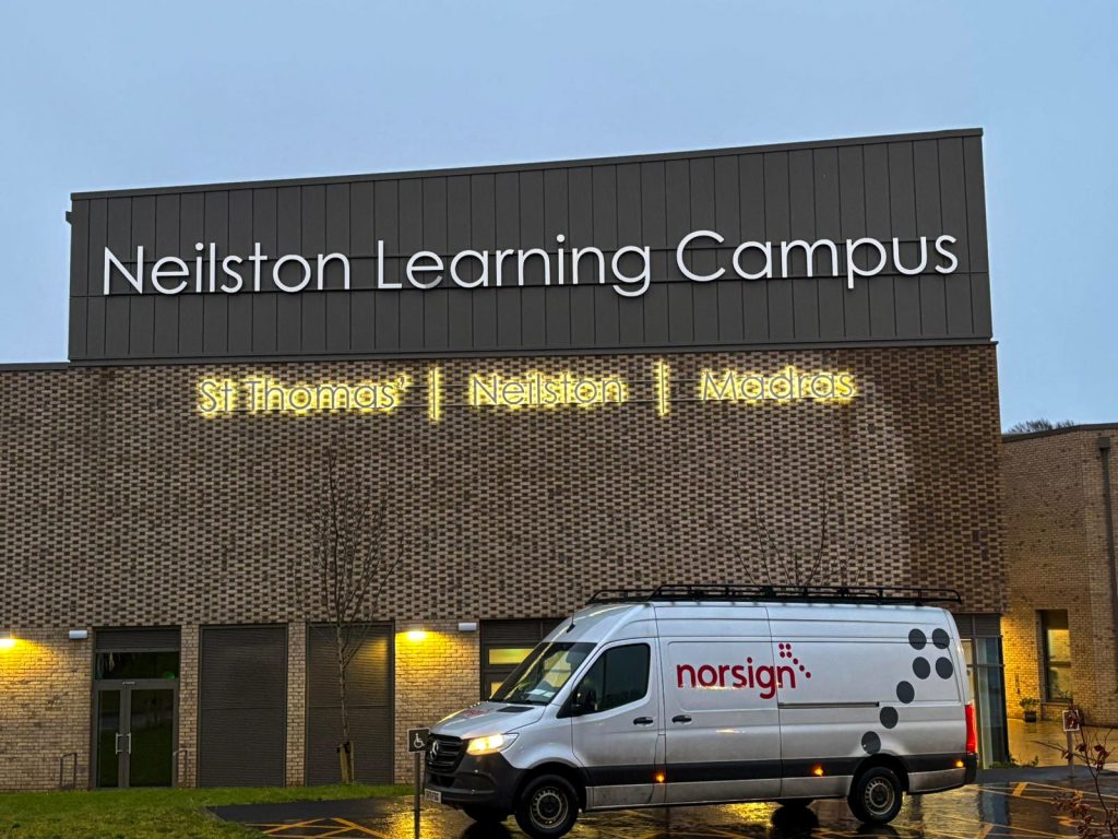 Norsign van parked in front of building signs after installation at Neilston Learning Campus